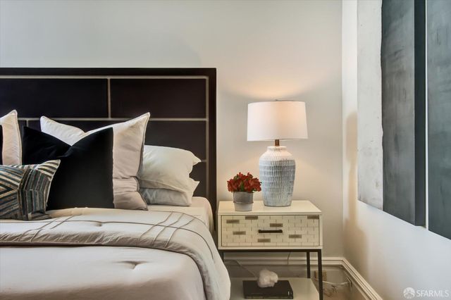 a bedroom with a bed and a lamp on table