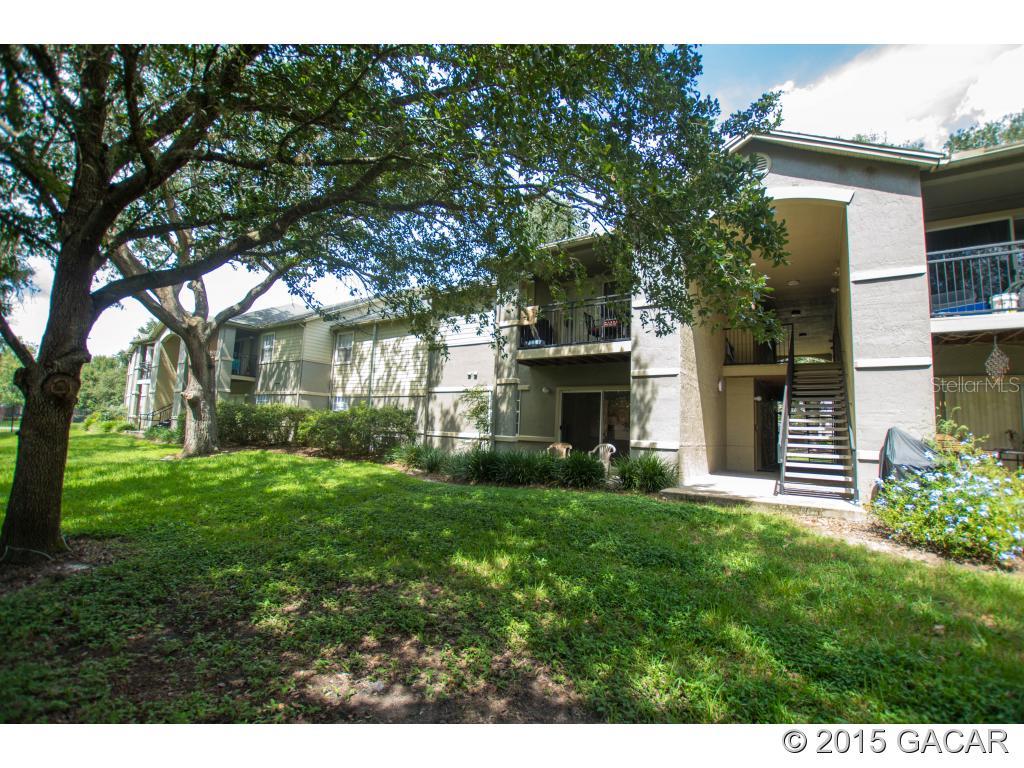3705 Southwest 27th Street, Unit 1114 Gainesville, FL 32608 - Photo 1 of 1 a house view with a garden space