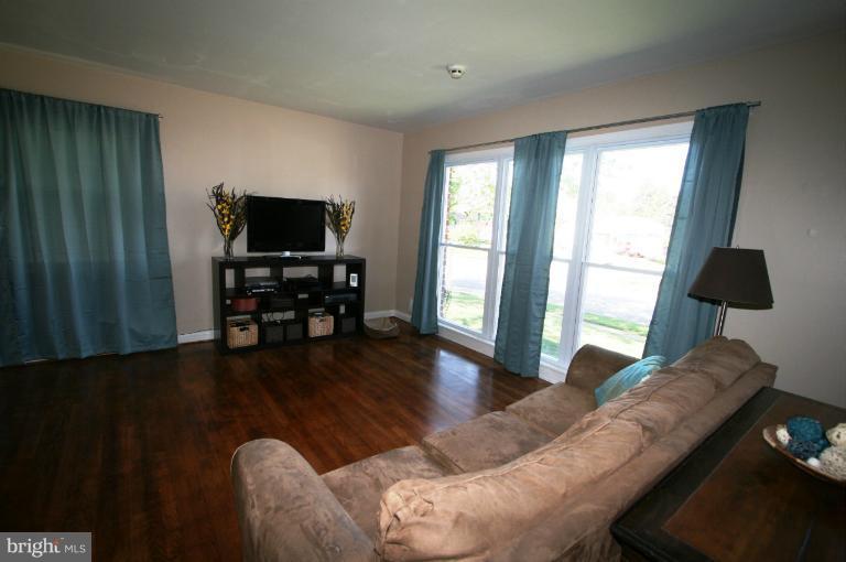 1001 Hartmont Road Catonsville, MD 21228 - Photo 25 of 29 a living room with furniture and a flat screen tv