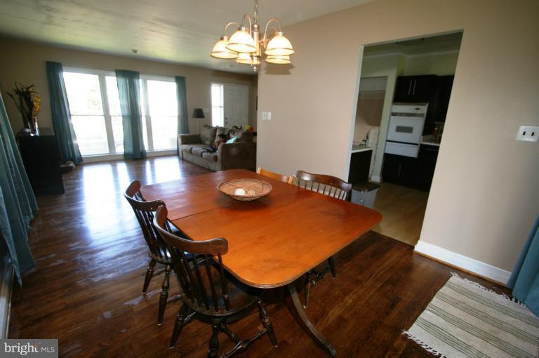1001 Hartmont Road Catonsville, MD 21228 - Photo 4 of 29 a view of a dining room with furniture and wooden floor