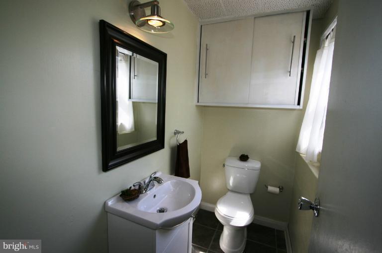1001 Hartmont Road Catonsville, MD 21228 - Photo 8 of 29 a bathroom with a toilet sink and mirror