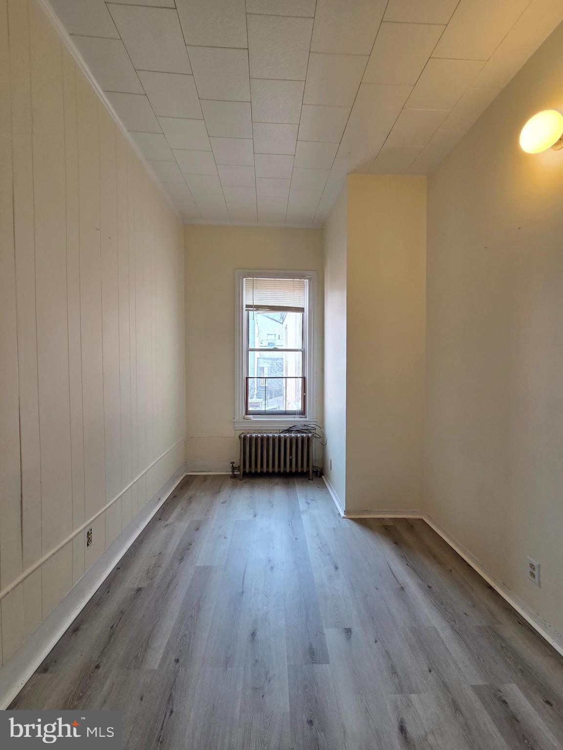 1712 Perkiomen Avenue Reading, PA 19602 - Photo 12 of 20 an empty room with wooden floor and windows