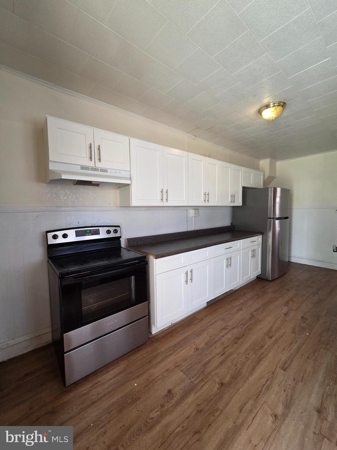 1712 Perkiomen Avenue Reading, PA 19602 - Photo 2 of 20 a kitchen with granite countertop a stove and cabinets