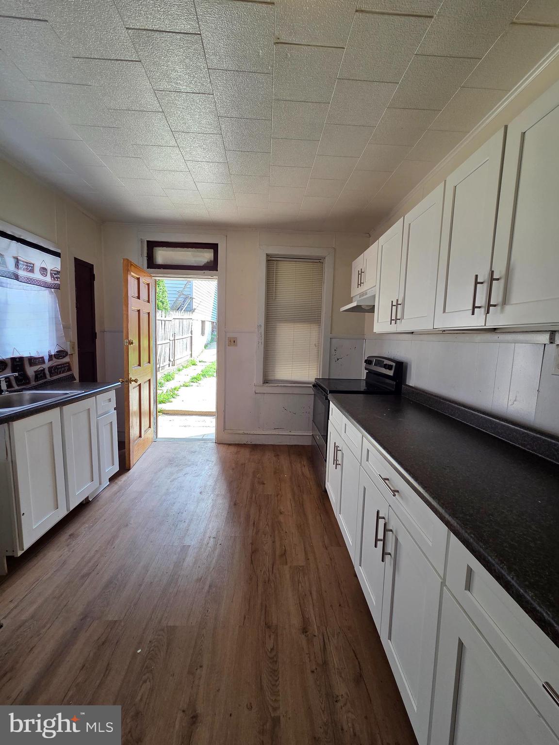 1712 Perkiomen Avenue Reading, PA 19602 - Photo 3 of 20 a large kitchen with cabinets wooden floor and stainless steel appliances