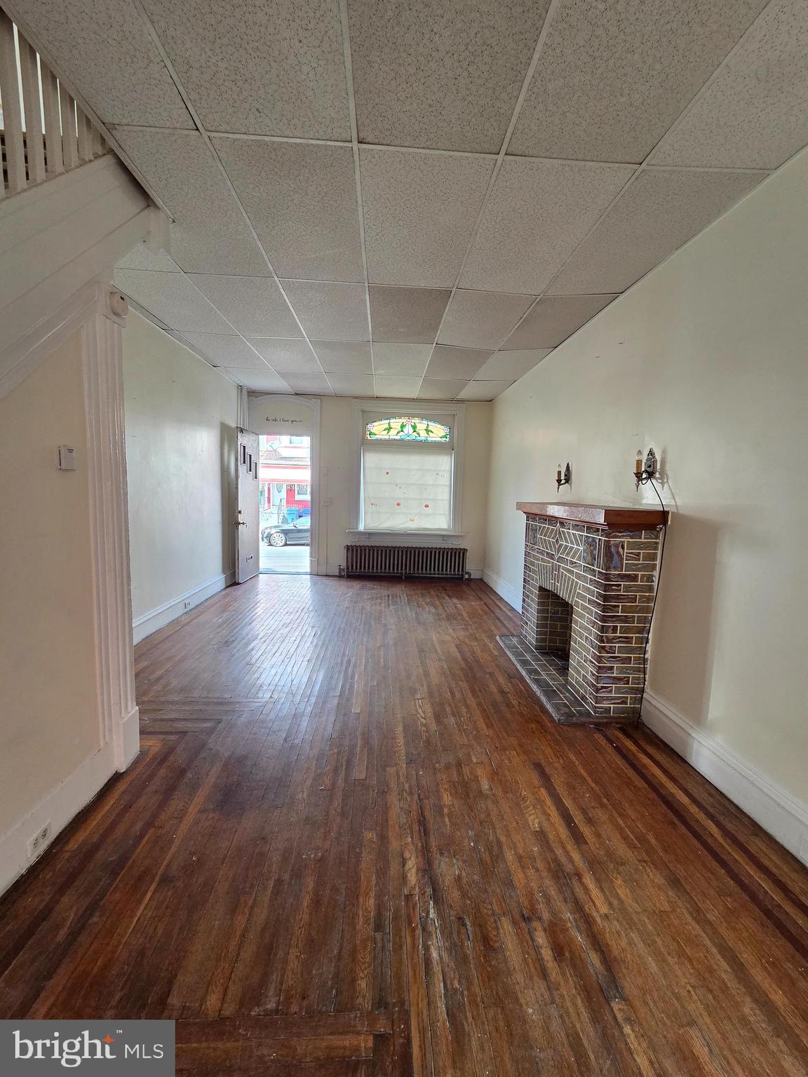 1712 Perkiomen Avenue Reading, PA 19602 - Photo 5 of 20 a big room with wooden floor fireplace and windows