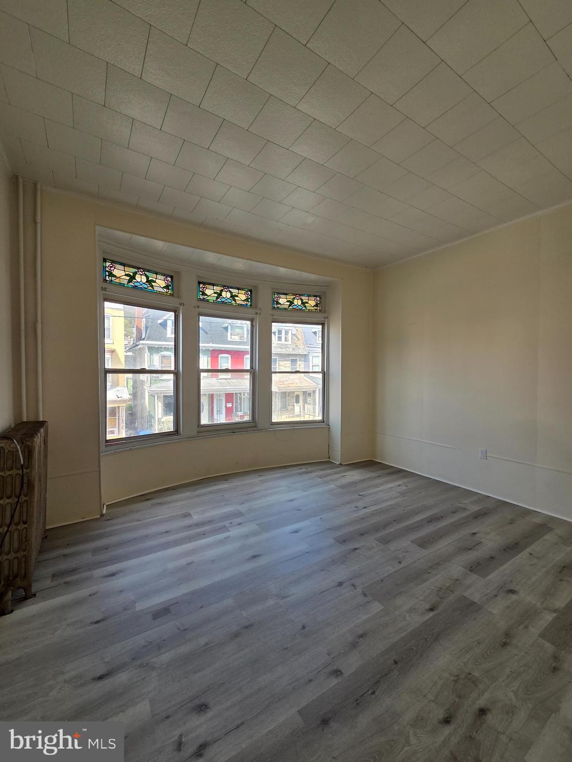 1712 Perkiomen Avenue Reading, PA 19602 - Photo 10 of 20 a view of an empty room with wooden floor and a window
