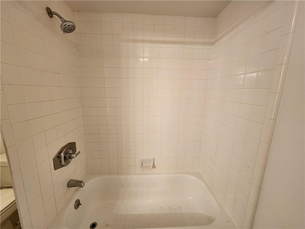 199 14th Street Northeast, Unit 209 Atlanta, GA 30309 - Photo 11 of 13 a bathroom with a bathtub