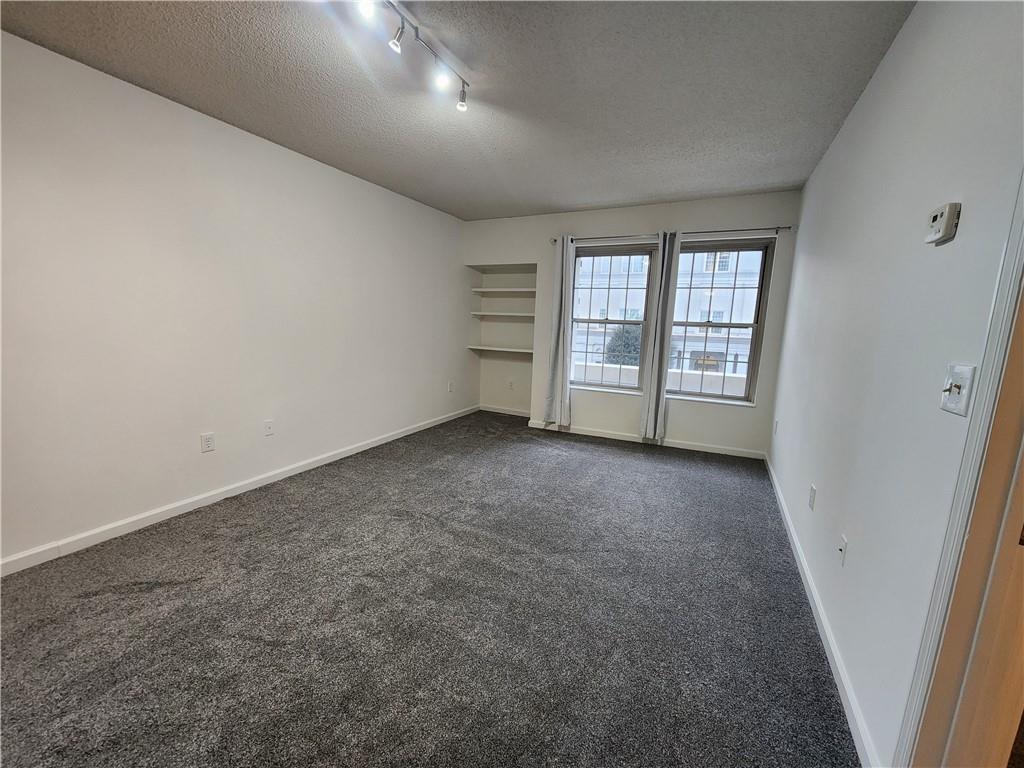 199 14th Street Northeast, Unit 209 Atlanta, GA 30309 - Photo 2 of 13 an empty room with windows
