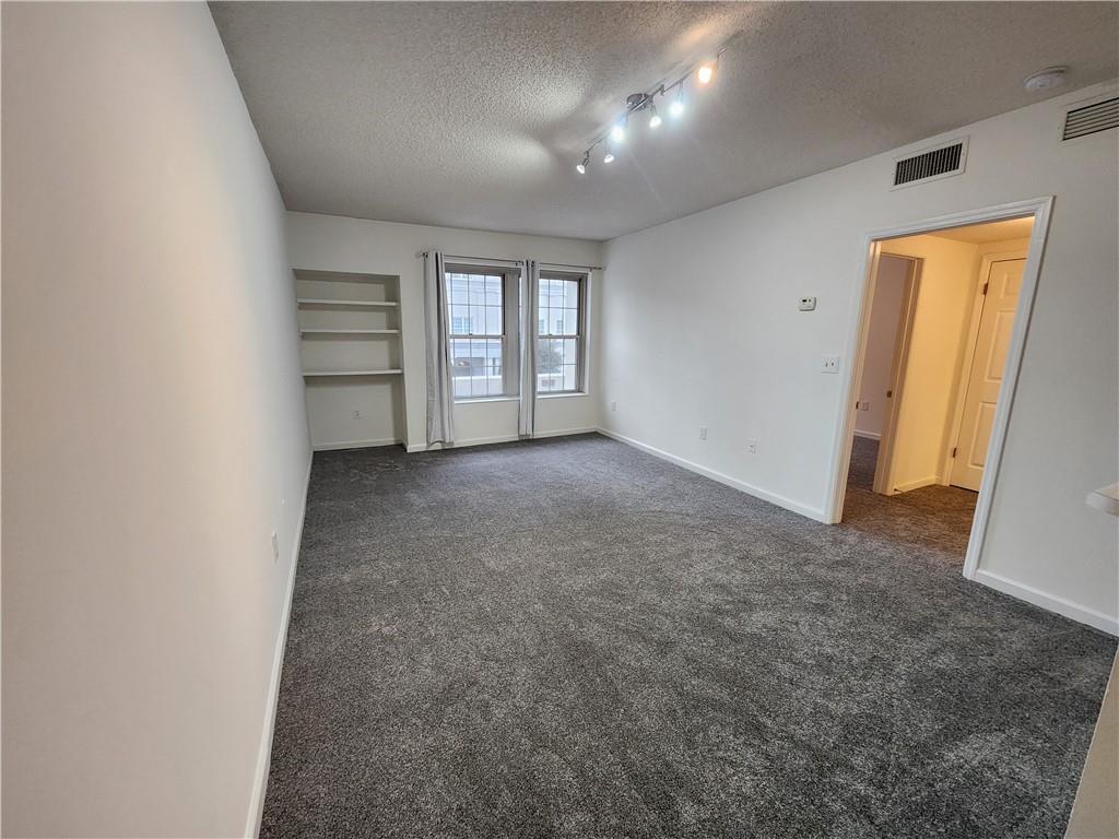199 14th Street Northeast, Unit 209 Atlanta, GA 30309 - Photo 3 of 13 an empty room with windows and closet