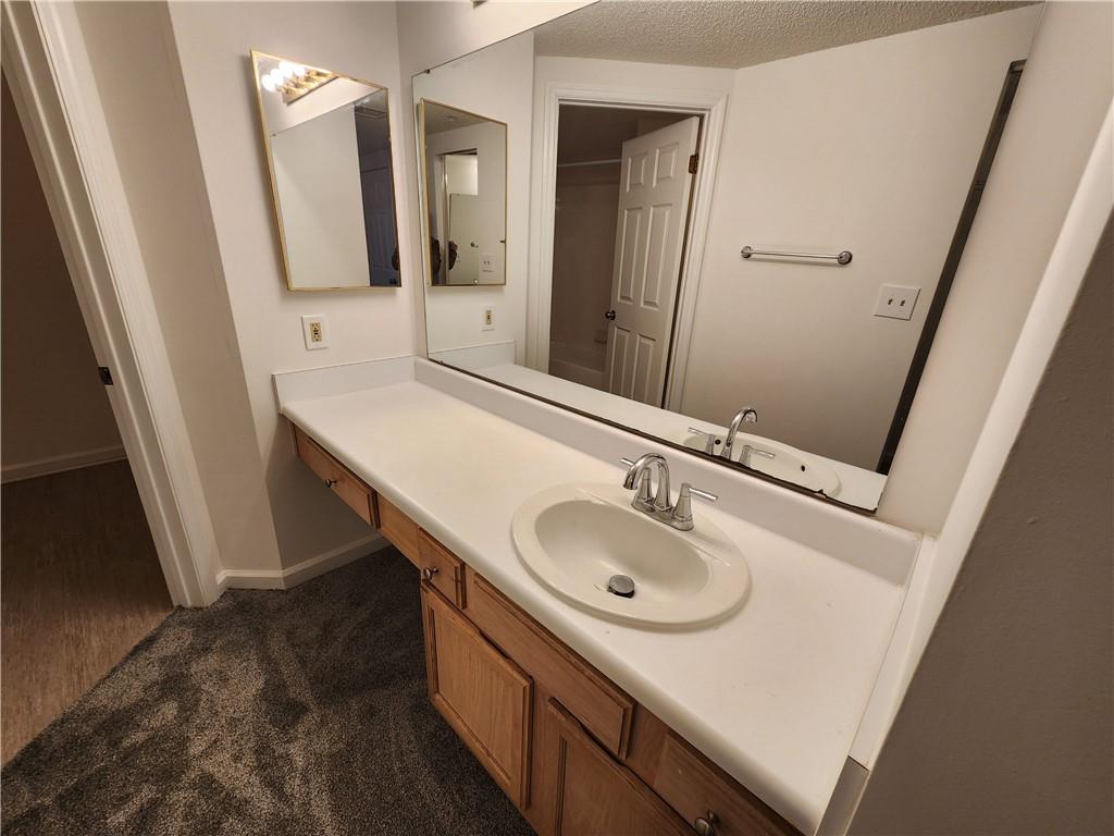 199 14th Street Northeast, Unit 209 Atlanta, GA 30309 - Photo 9 of 13 a bathroom with a sink and a mirror