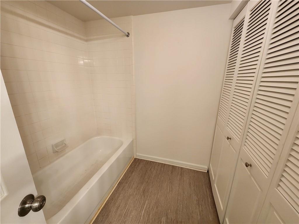 199 14th Street Northeast, Unit 209 Atlanta, GA 30309 - Photo 10 of 13 a bathroom with a bathtub
