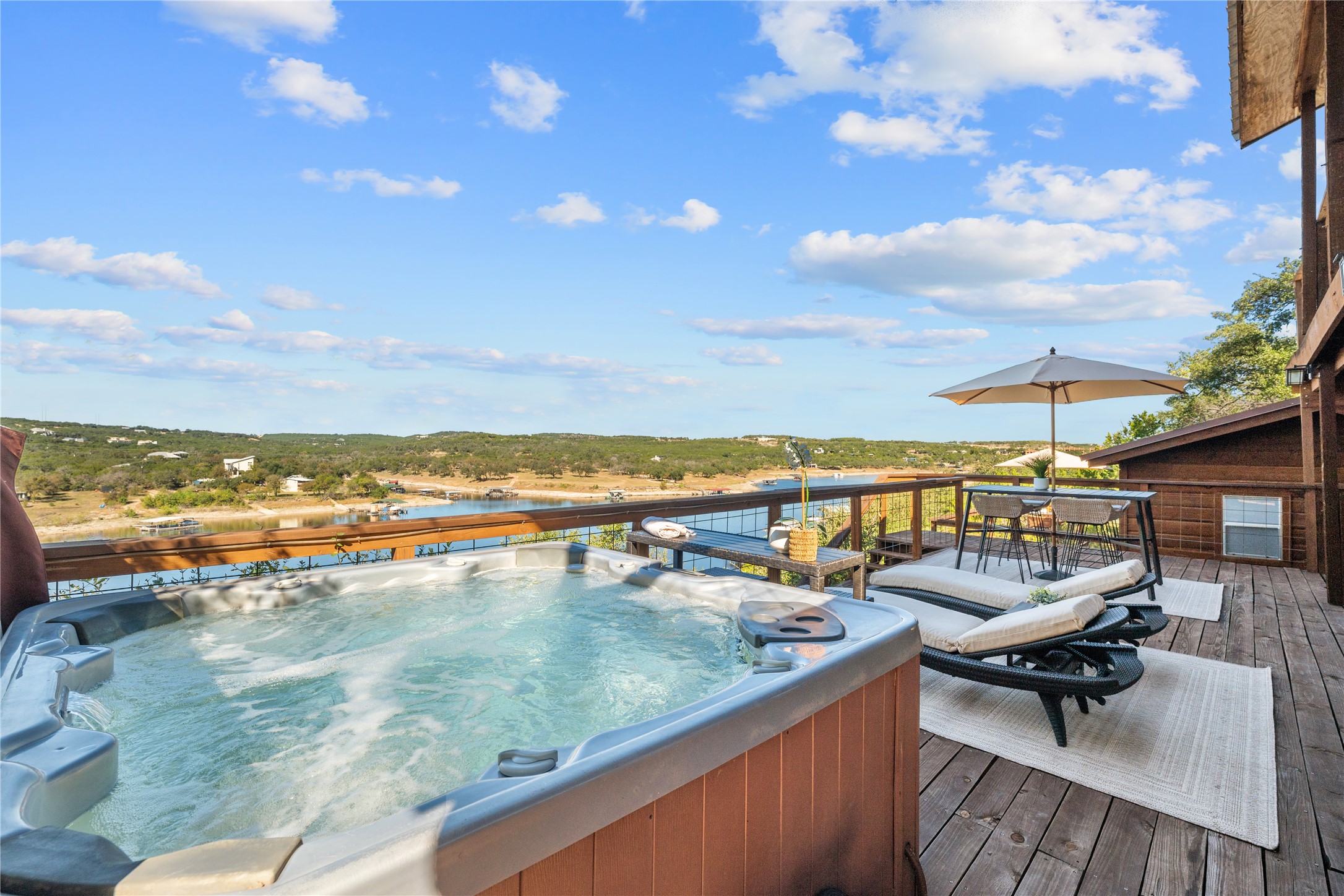 19645 Lakehurst Loop Spicewood, TX 78669 - Photo 25 of 40 Deck with a hot tub and a water view