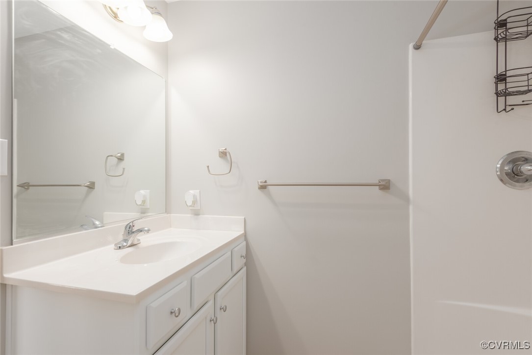 6336 Barrister Road Chesterfield, VA 23832 - Photo 21 of 39 a bathroom with a sink a mirror and a shower