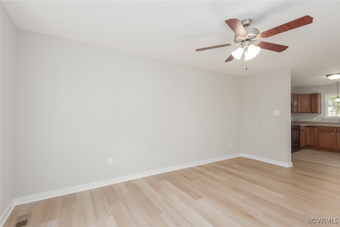 6336 Barrister Road Chesterfield, VA 23832 - Photo 8 of 39 a view of an empty room with wooden floor and a ceiling fan
