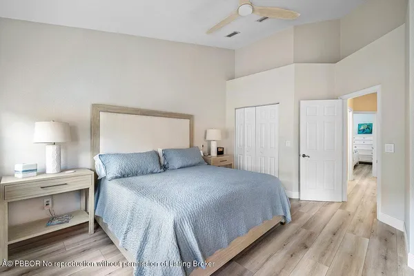 a bedroom with a large bed and a flat tv screen