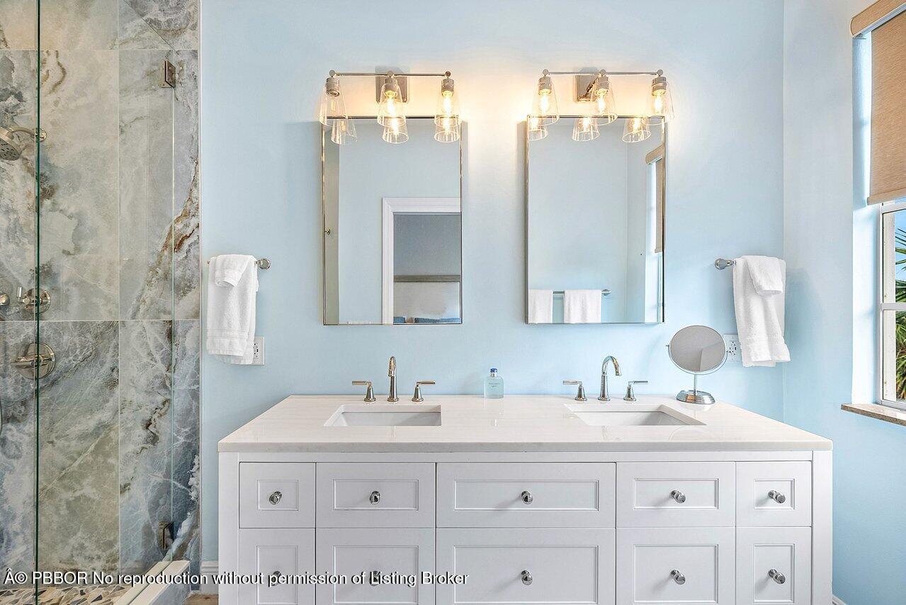 124 Harbors Way, Unit 124 Boynton Beach, FL 33435 - Photo 19 of 35 a bathroom with a sink vanity granite and a mirror