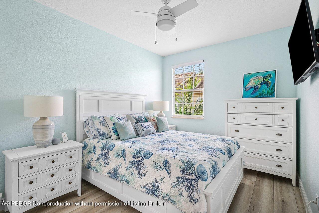 124 Harbors Way, Unit 124 Boynton Beach, FL 33435 - Photo 21 of 35 a bedroom with a bed and a flat screen tv