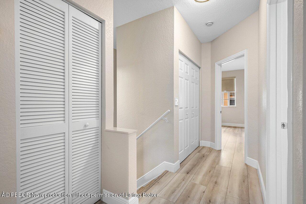 124 Harbors Way, Unit 124 Boynton Beach, FL 33435 - Photo 24 of 35 a view of a hallway with wooden floor and entryway