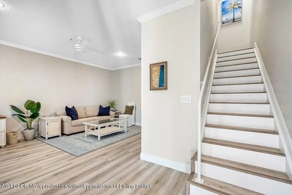 a living room with furniture and stairs