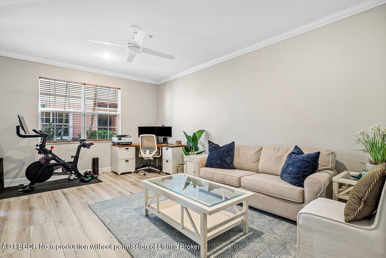 124 Harbors Way, Unit 124 Boynton Beach, FL 33435 - Photo 7 of 35 a living room with furniture or couch and a large window