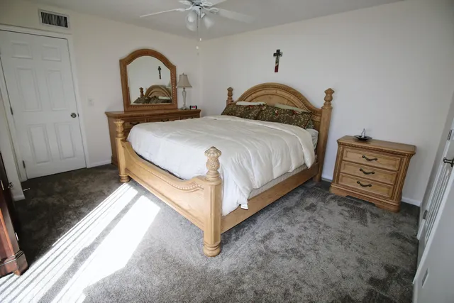 a spacious bedroom with bed and a window