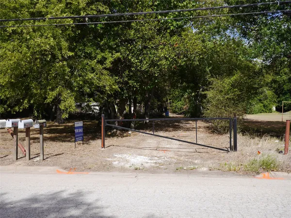 a view of backyard with table and chairs and wooden fence