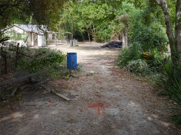 a view of a house with a yard and tree s