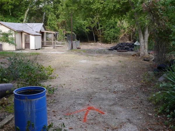 a backyard of a house with table and chairs
