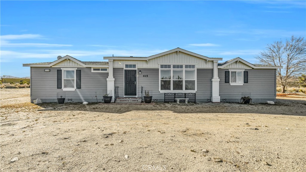 415 Goss Road Pinon Hills, CA 92372 - Photo 1 of 1 a front view of a house with a yard
