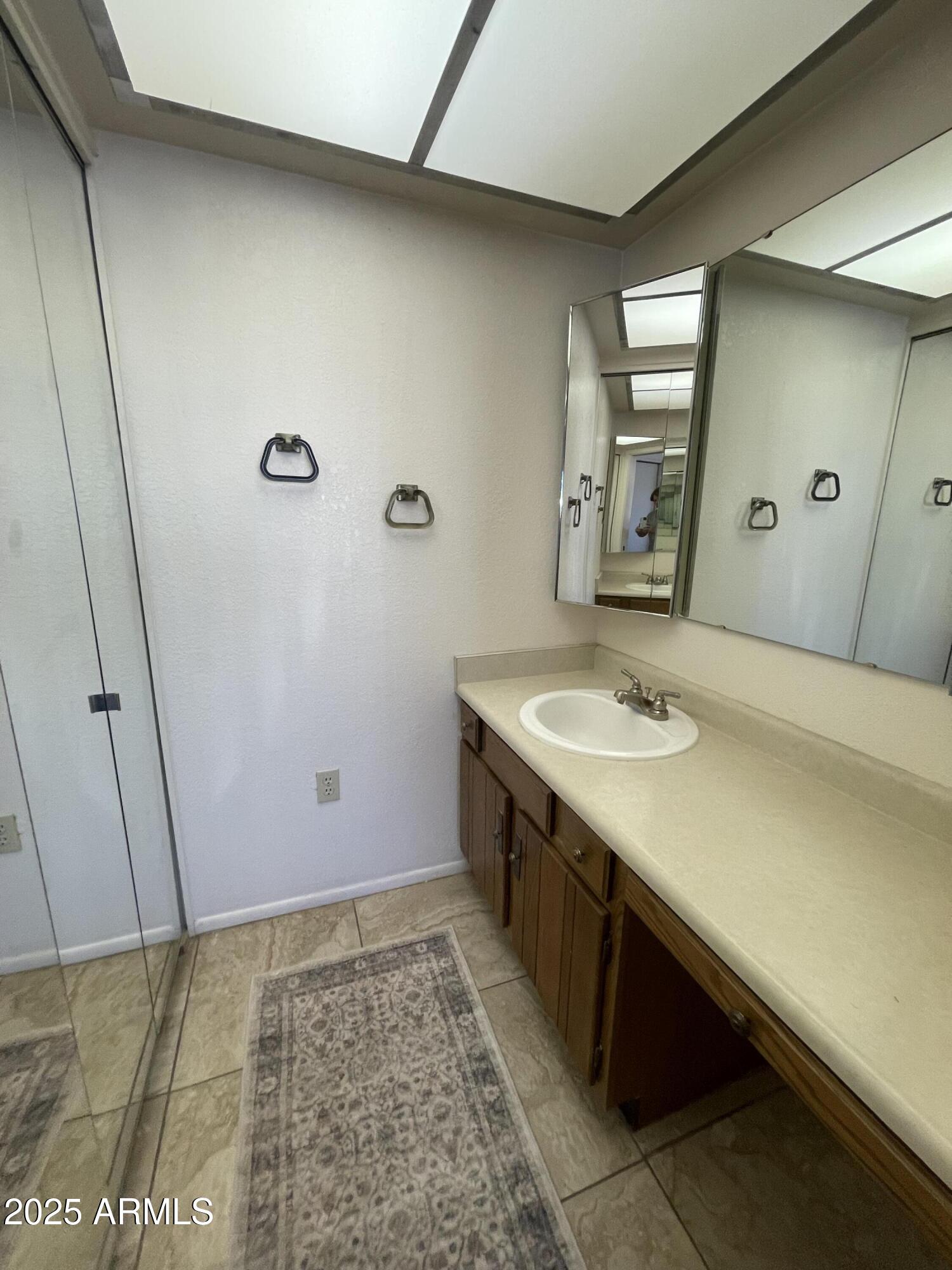 827 East Lancaster Circle Florence, AZ 85132 - Photo 11 of 24 a bathroom with a sink a mirror and a shower