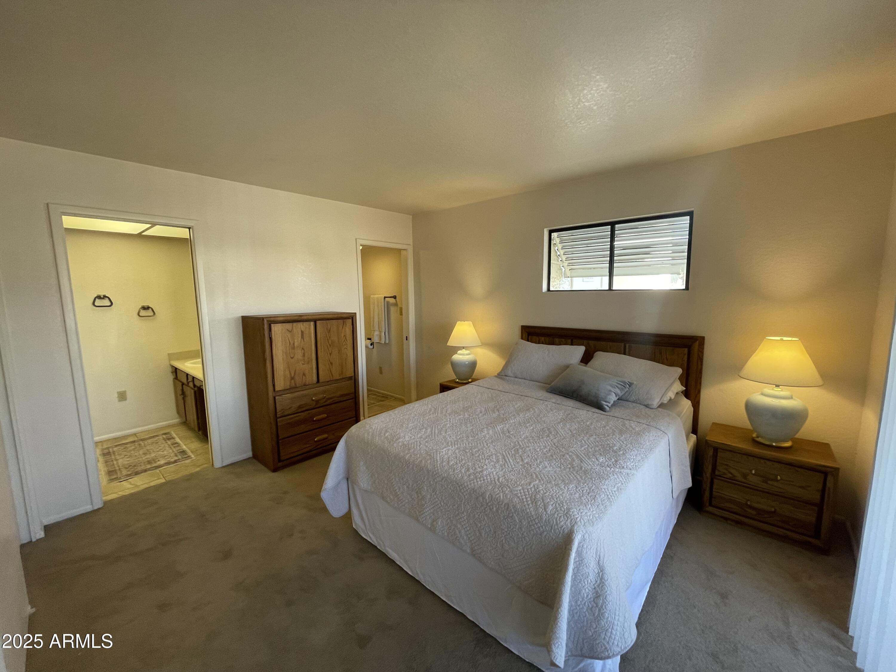 827 East Lancaster Circle Florence, AZ 85132 - Photo 9 of 24 a bedroom with a bed and a lamp