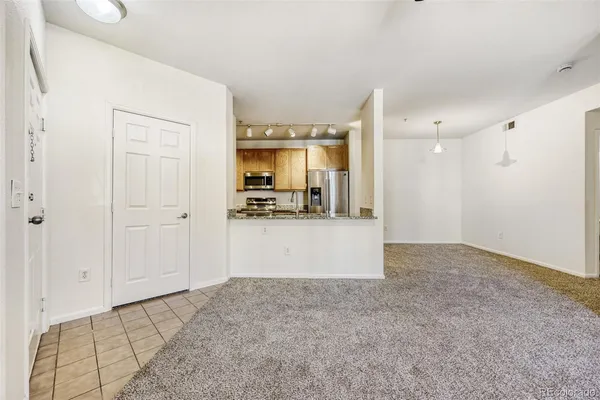an empty room with windows and fireplace