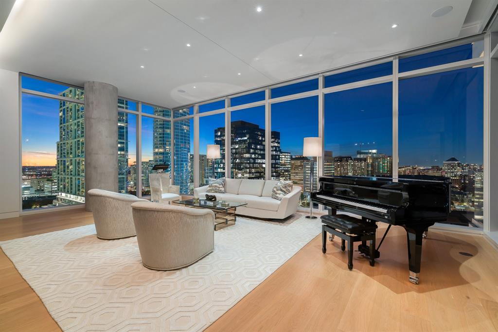 1747 Leonard Street, Unit 1401 Dallas, TX 75201 - Photo 1 of 1 a living room with furniture a piano and a fireplace