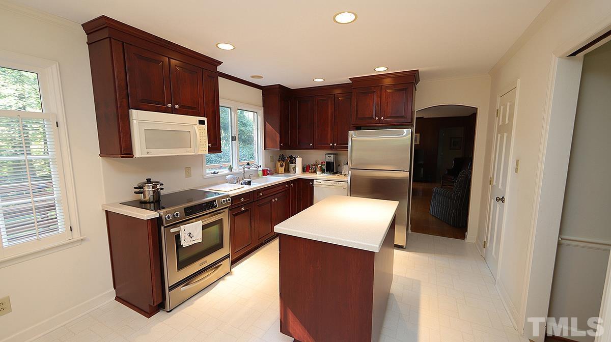 9005 Oneal Road Raleigh, NC 27613 - Photo 16 of 24 a kitchen with stainless steel appliances granite countertop a stove a refrigerator and a sink