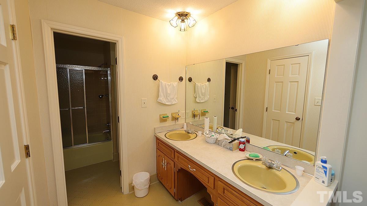 9005 Oneal Road Raleigh, NC 27613 - Photo 19 of 24 a bathroom with a sink double vanity and a shower
