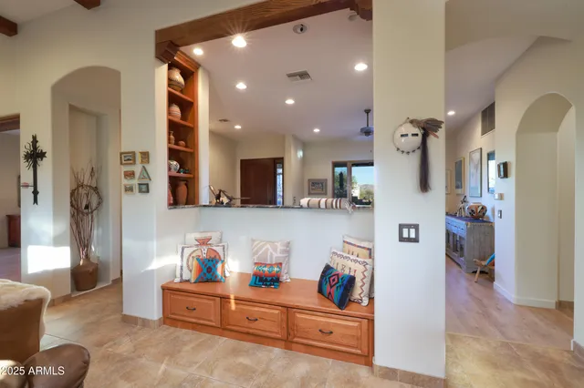 a living room with furniture and kitchen view