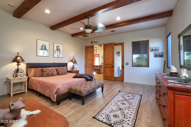 a spacious bedroom with a bed a couch and a dresser