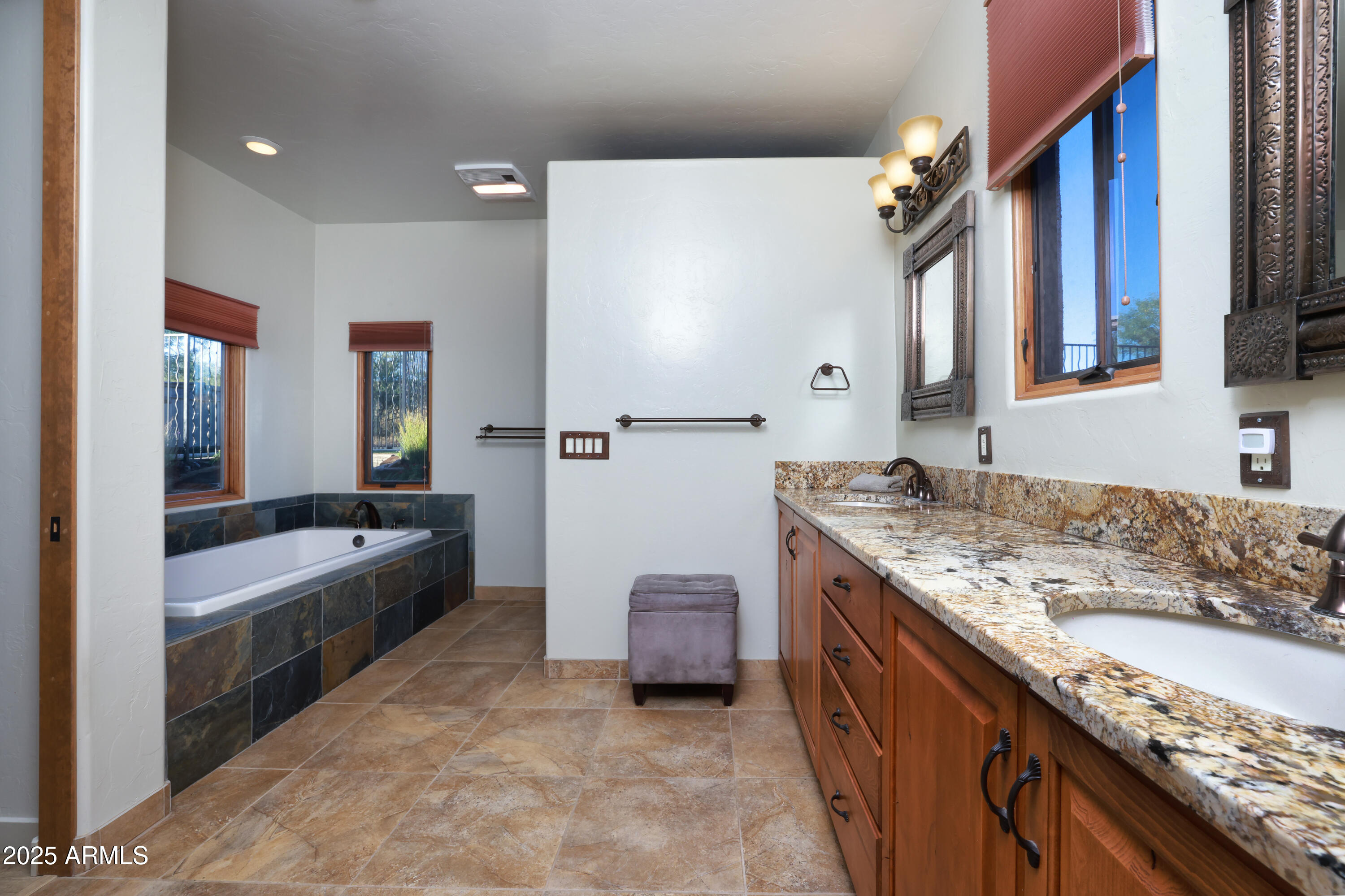 12800 West Arivaca Road Amado, AZ 85645 - Photo 23 of 48 a bathroom with a granite countertop tub a double vanity sink and a large mirror