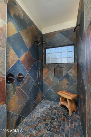 a bathroom with a glass shower door