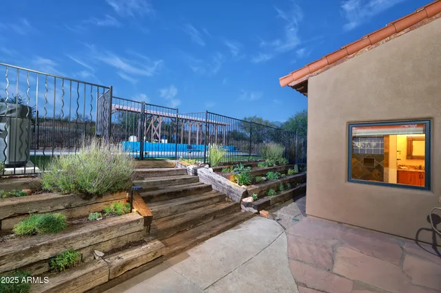 a view of a backyard with swimming pool
