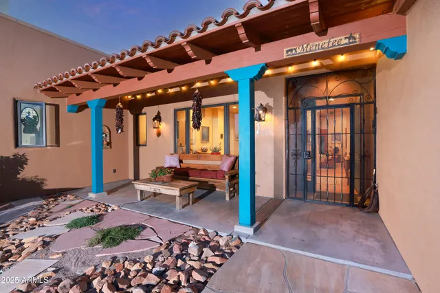 a view of a porch with chairs and backyard