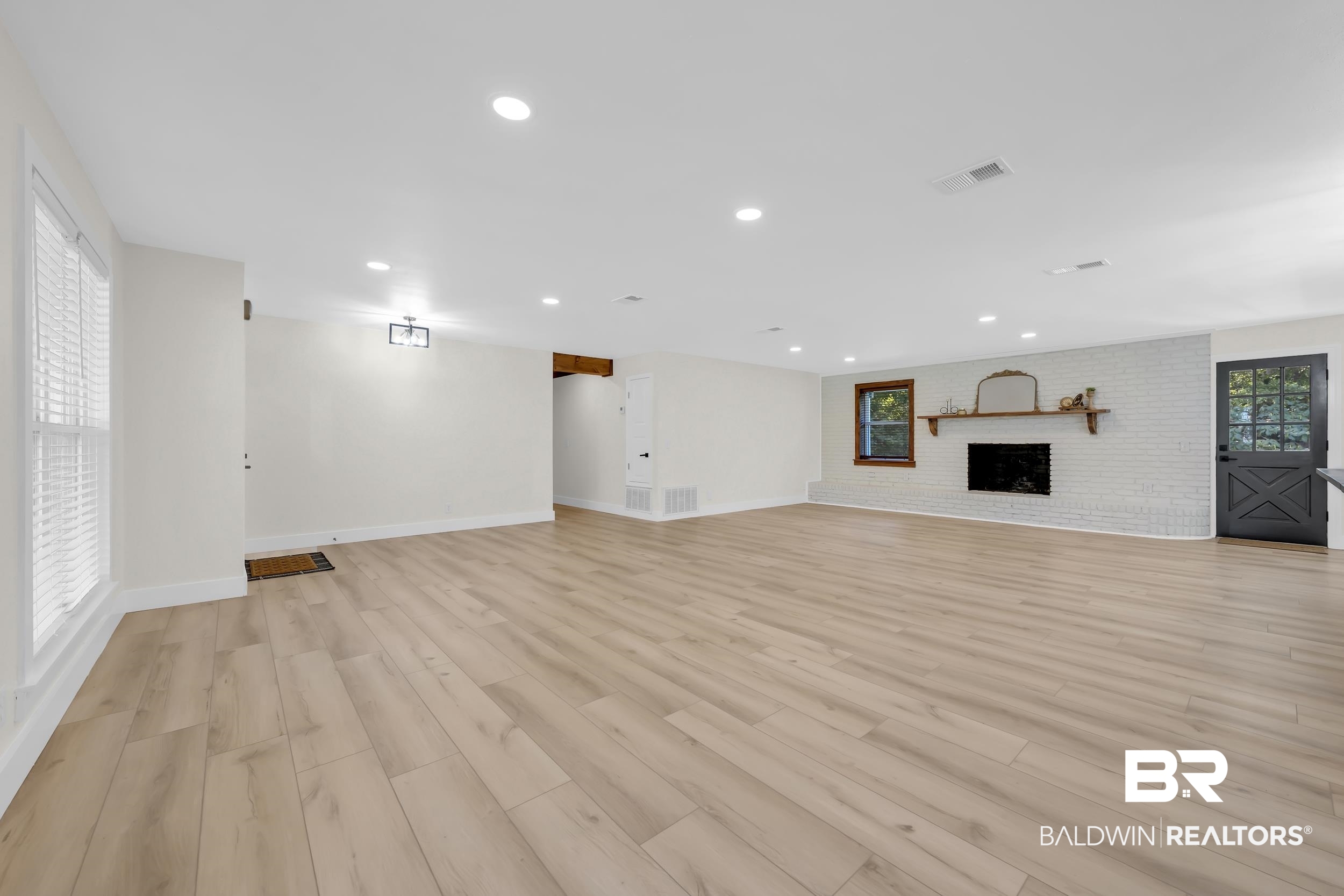 8170 Wilmer Georgetown Road Wilmer, AL 36587 - Photo 5 of 31 Spacious interior featuring wood-finish flooring, recessed lighting, and a white brick fireplace