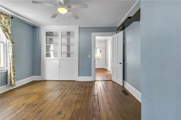 wooden floor in an empty room with a window