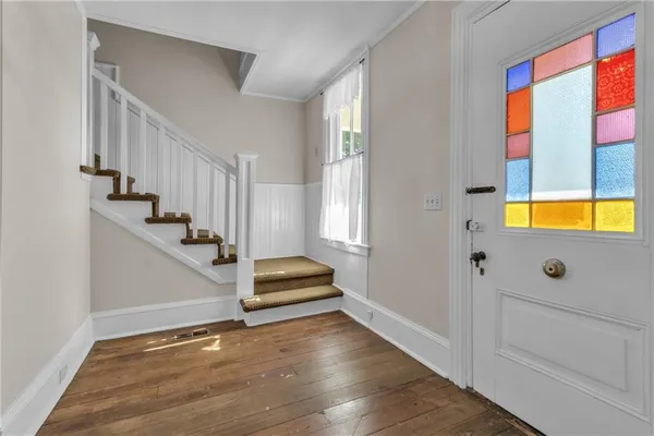 a view of entryway and hall with wooden floor