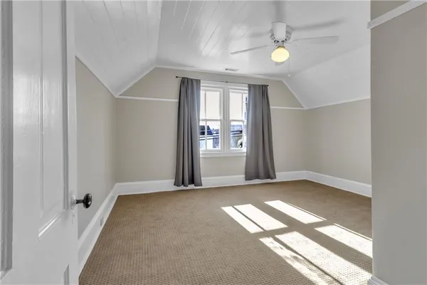 an empty room with windows and entrance