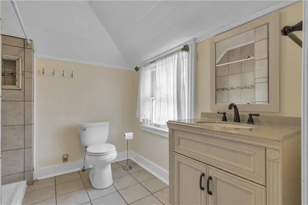 a bathroom with a sink a toilet and a window