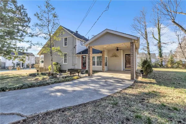 a backyard of a house with outdoor seating