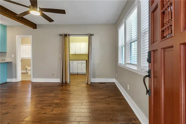 a view of an entryway with wooden floor and windows