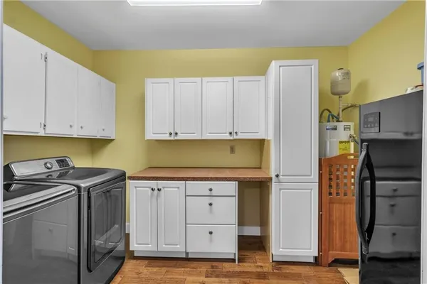 a kitchen with a refrigerator a stove and cabinets