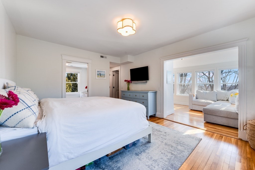 21 Arborough Road Boston, MA 02131 - Photo 14 of 40 a spacious bedroom with a bed and wooden floor